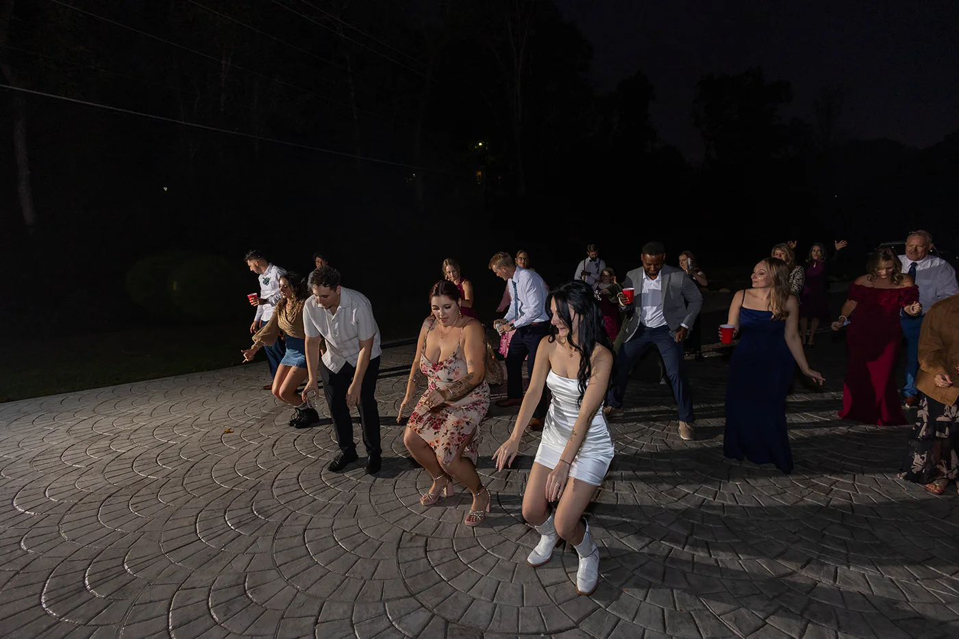 Guests line dancing during an evening reception at Lindsey Creek