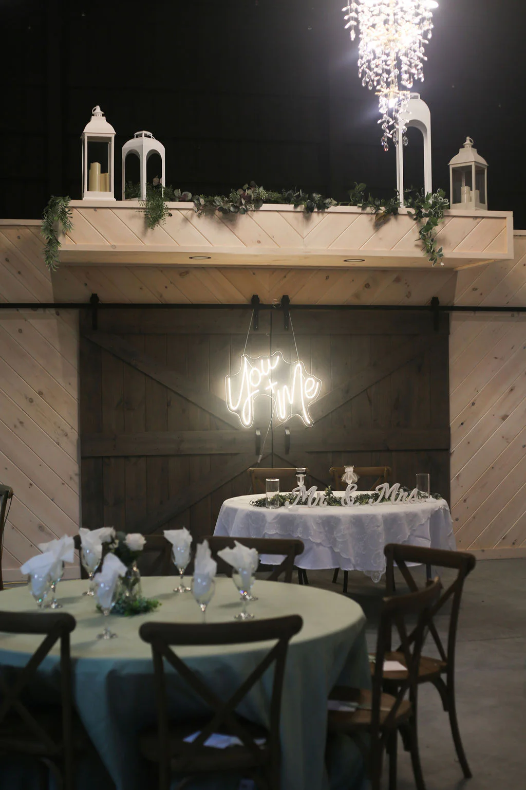 Wedding reception tables inside the celebration barn at Lindsey Creek