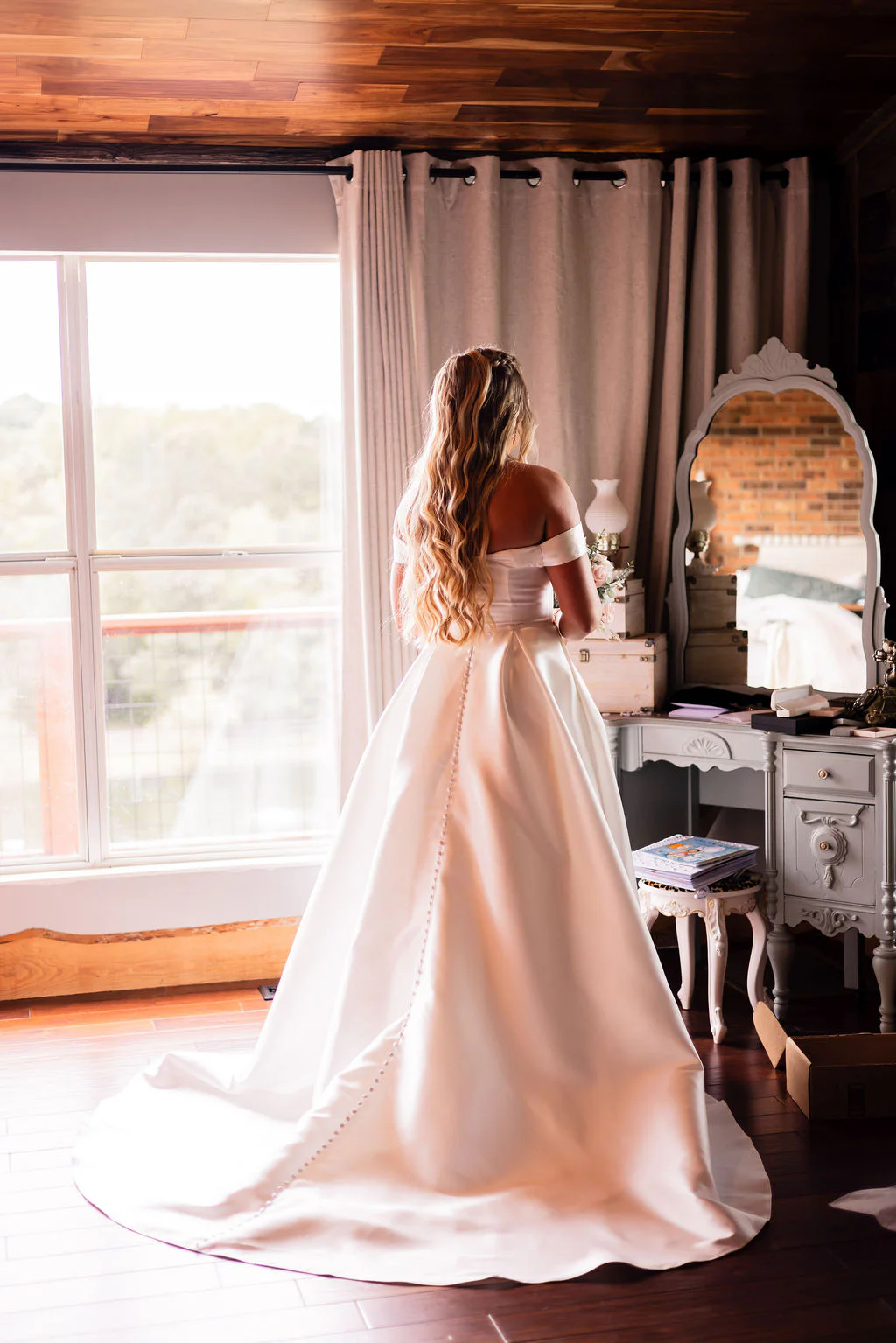 Bride standing in the getting-ready suite at Pondside